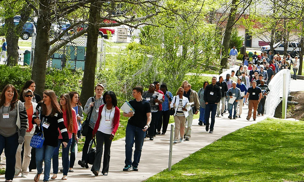 Students walking on Rhema Bible College campus, in a concrete walkway and with green vegetation
